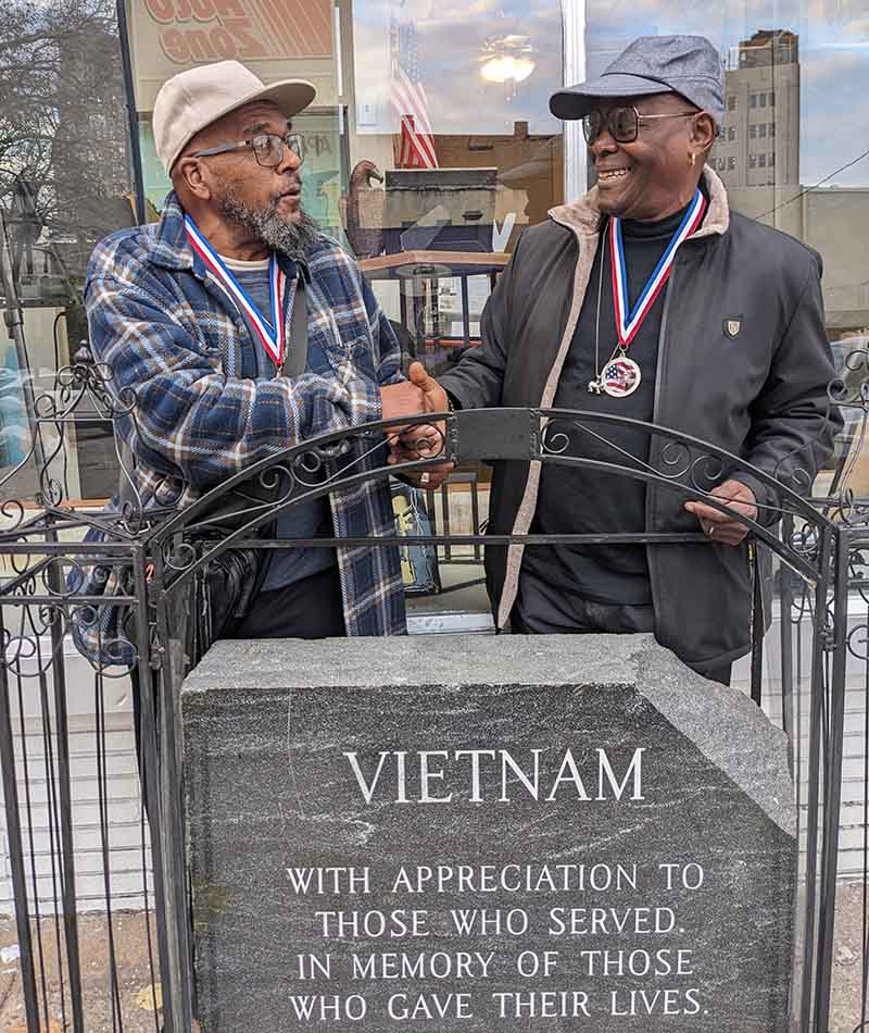2 Veterans at Vietnam Memorial Plaque